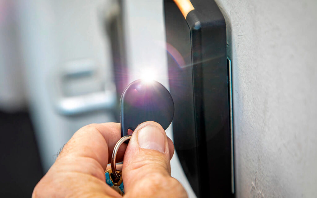 Person using key fob card reader entering building