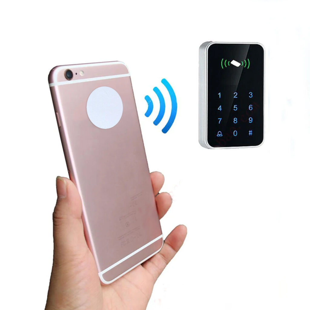 Person holding smartphone with coin tag on access control reader